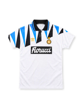 Inter Milan 1992-93 away jersey, front view, white with blue and black jagged shoulder pattern, black polo collar, gold Umbro logo, round club crest with star, Fiorucci sponsor on black box