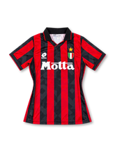 AC Milan 1992-94 home jersey, front view, red and black vertical stripes with tonal diamond pattern, black polo collar, white Lotto logo, gold star and Scudetto shield, white Motta sponsor