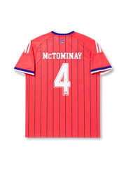 Scotland 2026 away shirt with MCTOMINAY #4, coral-orange body, navy vertical pinstripes, Scotland crest, Trefoil branding, and matching front and back player print.