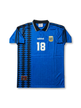 Front view of Argentina 1994-style away shirt in royal blue with black geometric side panel, AFA crest, black collar, and white number 18.