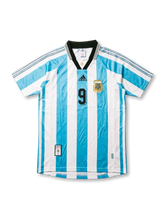 Front view of Argentina 1998 World Cup home shirt with sky blue and white stripes, black collar, AFA crest, black chest logo, and number 9 on the front.