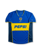 Front view of Boca Juniors 2004-05 home shirt in royal blue with gold chest band, Pepsi sponsor, centered swoosh, and CABJ crest.