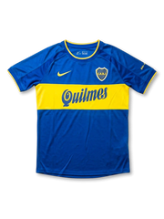 Front view of Boca Juniors home shirt in blue with yellow chest band, Quilmes sponsor, yellow swoosh, and CABJ crest.