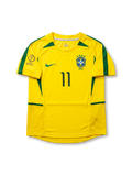 Front view of Brazil 2002 World Cup home shirt in yellow with green trim, CBF crest, Korea/Japan 2002 tournament print, and number 11 on the front.