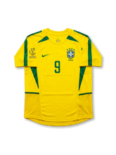 Front view of Brazil 2002 World Cup home shirt in yellow with green trim, CBF crest, Korea/Japan 2002 tournament print, and number 9 on the front.
