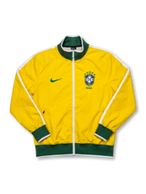 Brazil national team Nike track jacket in canary yellow with green ribbed collar and hem, white shoulder piping, green Swoosh at left chest, five-star CBF crest and BRASIL wordmark at right chest