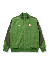 Chelsea FC Nike heritage track jacket in bright green with allover LONDON CFC typography print, vintage lion crest at chest, olive green raglan sleeves