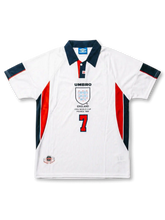 Front view of England 1998 World Cup home shirt in white with navy collar, red side panels, England crest, tournament print, and number 7 on the front.