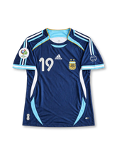 France 1998 FIFA World Cup home jersey featuring Thierry Henry #12, adidas blue soccer shirt with a red chest band, thin white horizontal stripes, white V-neck collar, red white and blue shoulder stripes, France national team rooster crest, white front number 12, and HENRY name with number 12 on the back.