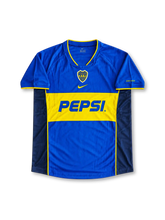 Boca Juniors 2004/05 Home Jersey Juan Román Riquelme #10, retro Argentine club soccer shirt featuring the iconic blue body with a yellow chest band, Boca Juniors club crest, and Riquelme name and number 10 on the back.