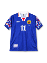 Japan 1997/98 Home Jersey Kazu #11, retro Japan national team soccer shirt featuring a blue design with red flame-inspired details, Japan national team crest, and player name and number 11 on the back.