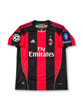 AC Milan 2010/11 UEFA Champions League Home Jersey Ronaldinho #80, classic adidas soccer shirt featuring red and black vertical stripes, AC Milan club crest, Fly Emirates sponsor logo, and Ronaldinho name and number 80 on the back.