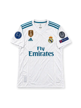 Real Madrid 2017/18 UEFA Champions League Home Jersey Cristiano Ronaldo #7, classic white adidas soccer shirt featuring blue and turquoise accents, Real Madrid crest, Fly Emirates sponsor logo, UEFA Champions League sleeve badge, and Ronaldo name and number 7 on the back.