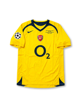 Arsenal FC 2006 UEFA Champions League Final Away Jersey Thierry Henry #14, classic Nike yellow soccer shirt featuring navy blue accents, Arsenal club crest, O2 sponsor logo, and Henry name and number 14 on the back.