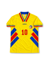 Romania 1994 FIFA World Cup Home Jersey Gheorghe Hagi #10, retro Romanian national team soccer shirt featuring the iconic yellow base with blue and red geometric details, Romania national team crest, manufacturer branding, and Hagi name and number 10 on the back.