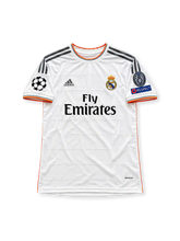 レアル・マドリード 2014/15シーズン ホームユニフォーム クリスティアーノ・ロナウド7番 adidas製ホワイトのボディにブラックのスリーストライプス、ピンクのサイドラインと背面のアクセント、同色の星形ジャカード柄、ボタン付き襟、ブラックのFly Emiratesスポンサーロゴ、レアル・マドリードのクラブエンブレム、背面のRONALDOネームと7番を配したレトロサッカージャージ