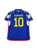 Front view of Japan 2022 World Cup home shirt with blue origami-inspired pattern, Japan crest, yellow #10 print, red trim, and Qatar 2022 sleeve patch.