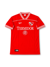 Independiente 1990s home jersey #10, late 1990s Topper red soccer shirt with thin white horizontal piping, white V-neck collar and sleeve cuffs featuring red geometric patterns, TERMIDOR sponsor logo, C.A.I. club crest, and large white number 10 with Topper branding on the back.