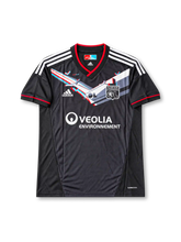 Olympique Lyonnais 2011-12 away jersey featuring Lisandro Lopez #9, adidas black soccer shirt with gray diagonal graphics, red-trimmed V-neck, white three-stripe shoulder detailing, VEOLIA ENVIRONNEMENT sponsor logo, Lyon club crest, and LISANDRO name and number 9 on the back.