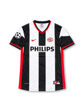PSV Eindhoven 1998-99 away jersey featuring Ruud van Nistelrooy #8, Nike black and white vertically striped soccer shirt with red-trimmed V-neck collar, red Nike Swoosh, PHILIPS sponsor logo, PSV Eindhoven crest, UEFA Champions League sleeve patch, and V.NISTELROOY name and number 8 on the back.