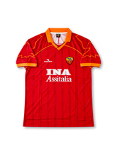AS Roma 1997-98 home jersey featuring Francesco Totti #10, Diadora deep red soccer shirt with orange V-neck collar, curved orange side panels, subtle Colosseum-inspired tonal pattern, white INA Assitalia sponsor logo, AS Roma club crest, and orange TOTTI name and number 10 on the back.