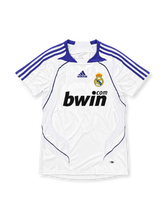 Real Madrid 2007-08 home jersey featuring Ruud van Nistelrooy #17, white adidas soccer shirt with a purple fold-over V-neck collar, purple three-stripe shoulder detailing, curved purple piping, black bwin.com sponsor logo, Real Madrid club crest, and V. NISTELROOY name with purple number 17 on the back.