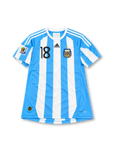Argentina 2010 FIFA World Cup home jersey featuring Lionel Messi #10, adidas sky blue and white vertically striped soccer shirt with a white crew neck, white three-stripe shoulder detailing, black adidas logo, black number 10 on the chest, two-star Argentina AFA crest, and MESSI name and number 10 on the back.