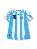 Argentina 2010 FIFA World Cup home jersey featuring Lionel Messi #10, adidas sky blue and white vertically striped soccer shirt with a white crew neck, white three-stripe shoulder detailing, black adidas logo, black number 10 on the chest, two-star Argentina AFA crest, and MESSI name and number 10 on the back.
