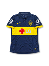 Boca Juniors 2007-08 home jersey featuring Juan Roman Riquelme #10, Nike dark navy blue soccer shirt with a bold yellow horizontal chest band, yellow Nike Swoosh, Megatone sponsor logo, Boca Juniors CABJ crest, UNICEF sleeve branding, and RIQUELME name and number 10 on the back.