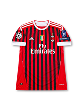 AC Milan 2011-12 home jersey featuring Zlatan Ibrahimovic #11, adidas red and black vertically striped soccer shirt with white crew neck collar, white sleeve cuffs and three-stripe shoulder detailing, Fly Emirates sponsor, gold-star AC Milan crest, Italian Scudetto shield, and IBRAHIMOVIĆ name with white number 11 on the back.