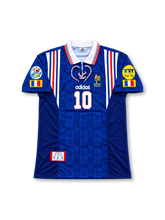 France 1996 UEFA European Championship home jersey featuring Zinedine Zidane #10, blue adidas soccer shirt with white and red shoulder stripes, French tricolor side detailing, white fold-over lace-up V-neck collar, subtle tonal fabric pattern, adidas branding, France national team rooster crest, front number 10, and ZIDANE name with number 10 on the back.
