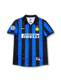 Front view of the 1998/99 Inter Milan home soccer jersey featuring black and blue vertical stripes, a yellow Nike Swoosh, Inter crest with gold star, white Pirelli sponsor, and UEFA Champions League sleeve patch.