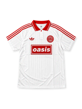 Front view of the white Oasis x adidas Originals Live '25 Tour Jacquard Jersey featuring red shoulder stripes, a red polo collar, adidas Trefoil logo, circular Live '25 badge, and red Oasis box logo.