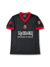 Front view of the black Iron Maiden The Book of Souls 2016 football jersey featuring a red V-neck collar, red sleeve trim, tonal all-over graphics, Eddie shield artwork, white band logo, and decorative sleeve patches.