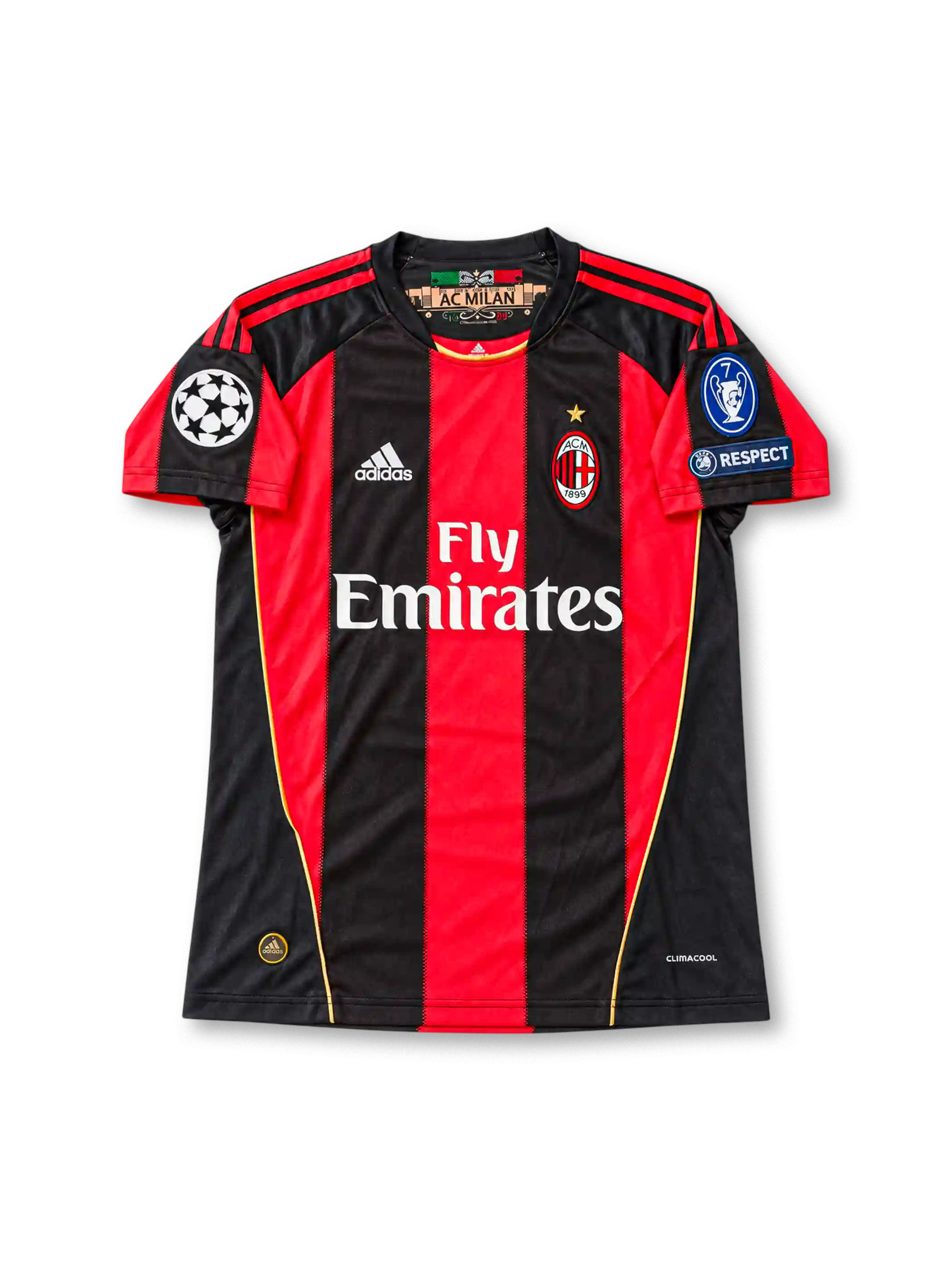 Front view of the 2010/11 AC Milan home soccer jersey featuring red and black vertical stripes, white adidas logo, Fly Emirates sponsor, club crest with gold star, UEFA Champions League starball patch, seven-time winners badge, and UEFA Respect patch.