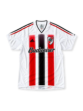 Front view of the 2010/11 AC Milan home soccer jersey featuring red and black vertical stripes, white adidas logo, Fly Emirates sponsor, club crest with gold star, UEFA Champions League starball patch, seven-time winners badge, and UEFA Respect patch.