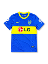 Boca Juniors 2010-11 home soccer jersey featuring Juan Román Riquelme #10, royal blue fabric, a wide yellow chest band, yellow Nike Swoosh, CABJ crest, LG sponsor, and Total sleeve branding.