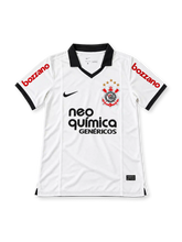 Front view of the Corinthians 2011-12 white home football jersey associated with Adriano #10, featuring a black polo collar and sleeve trim, Nike swoosh, Corinthians crest, Neo Química Genéricos chest sponsor, and red Bozzano sleeve branding.