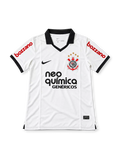 Front view of the Corinthians 2011-12 white home football jersey associated with Adriano #10, featuring a black polo collar and sleeve trim, Nike swoosh, Corinthians crest, Neo Química Genéricos chest sponsor, and red Bozzano sleeve branding.