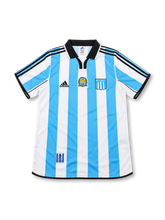 Racing Club 2000-01 home jersey by adidas featuring sky-blue and white vertical stripes, black polo collar, embroidered club crest and commemorative chest badge.