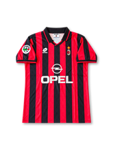 AC Milan 1995-96 home jersey by Lotto featuring red and black vertical stripes, black polo collar, Opel sponsor, club crest and Paolo Maldini number 3.