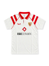 Front view of the Sevilla FC 1992-93 white home jersey featuring red shoulder stripes, a red polo collar, embroidered club crest, red chest logo, and EGE SERAMIK sponsor.