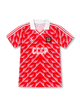 Front view of the Soviet Union 1987-1988 red home football jersey by Adidas, featuring a white collar, geometric red and white pattern, Soviet national crest and CCCP chest lettering.