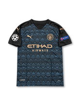 Manchester City 2020-21 dark navy and black PUMA away jersey featuring a geometric pattern, copper-colored club crest, PUMA logos, Etihad Airways sponsor and Sergio Aguero number 10.