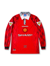 Manchester United 1996-98 red Umbro home long sleeve jersey featuring patterned sleeves, grey and white collar, Sharp sponsor, club crest and Eric Cantona number 7.