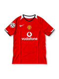 Manchester United 2004-06 red Nike Total 90 home jersey featuring white shoulder panels, black collar trim, club crest, Vodafone sponsor and Champions League starball sleeve patch.