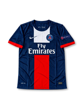Paris Saint-Germain 2013-14 navy Nike home jersey featuring a white upper-chest panel, red central stripe, red sleeve cuffs, PSG crest and Fly Emirates sponsor.
