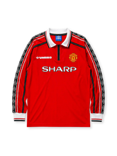 Manchester United 1998/99 home long sleeve jersey in red with diamond-pattern sleeve tape and Sharp branding