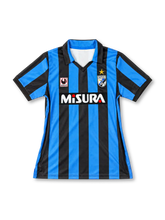 Inter Milan 1988-90 home jersey, front view, blue and black vertical stripes, black polo collar with open V-neck, Uhlsport logo patch, biscione crest with gold star, white Misura sponsor on black panel