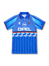Inter Milan 1995-96 away jersey, front view, white with blue, black and gold monogram collage on shoulders, striped polo collar, black Umbro logo, round club crest with star, black Pirelli sponsor